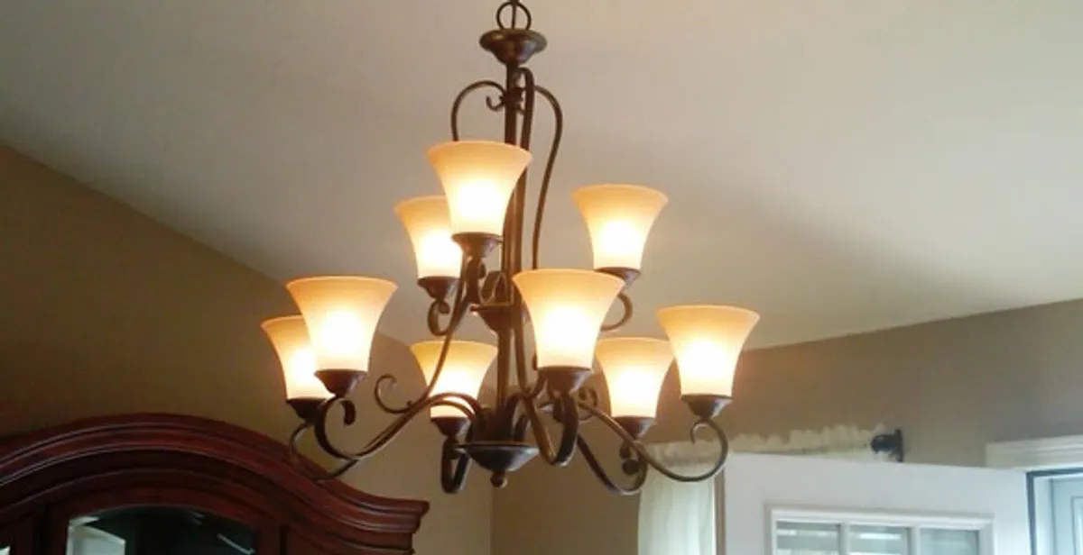 Classic ceiling chandelier installation with warm lighting in Littleton, CO