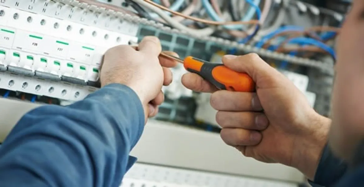 electrical service showing licensed electrician performing electrical panel maintenance and adjustments in Littleton, CO