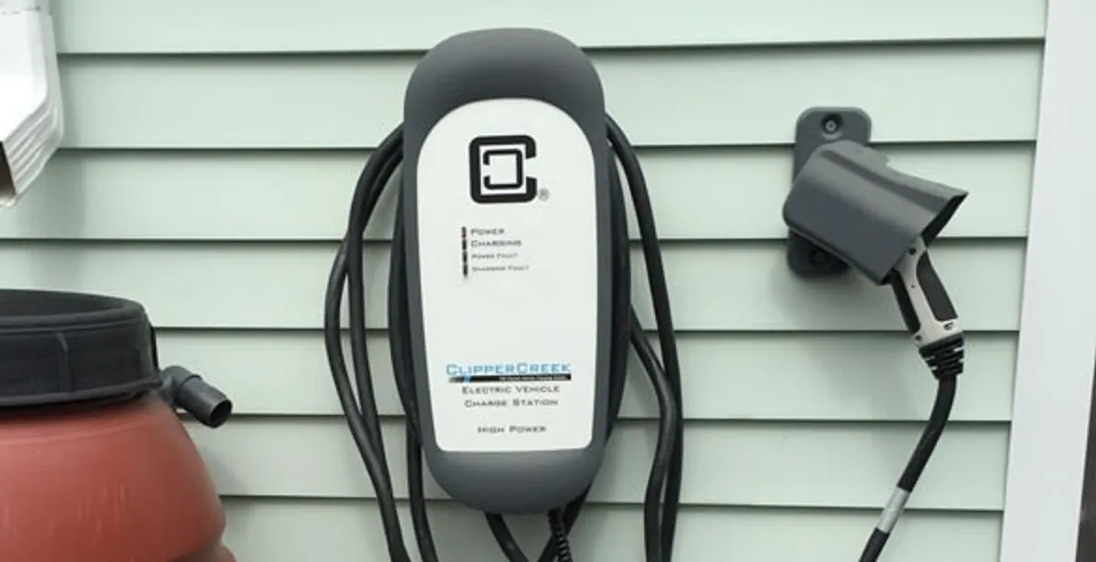 Outdoor electric vehicle charger installation on residential wall in Littleton, CO